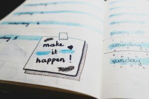 Writing Prompt Wednesday Close-up view of a planner page with motivational text and colorful designs.